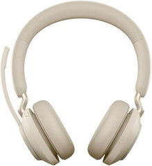 Jabra Evolve2 65 UC Stereo Wireless Headset with Link 380a and charging stand, featuring advanced noise isolation, powerful 40 mm speakers, three-microphone call technology, soft memory-foam ear cushions, and an elegant beige finish.