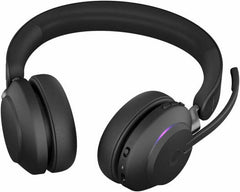 Jabra Evolve2 65 UC Stereo Wireless Headset with Link 380a and charging stand, featuring advanced noise isolation, 40 mm speakers, three-microphone call technology, plush memory-foam ear cushions, and a sleek black finish.
